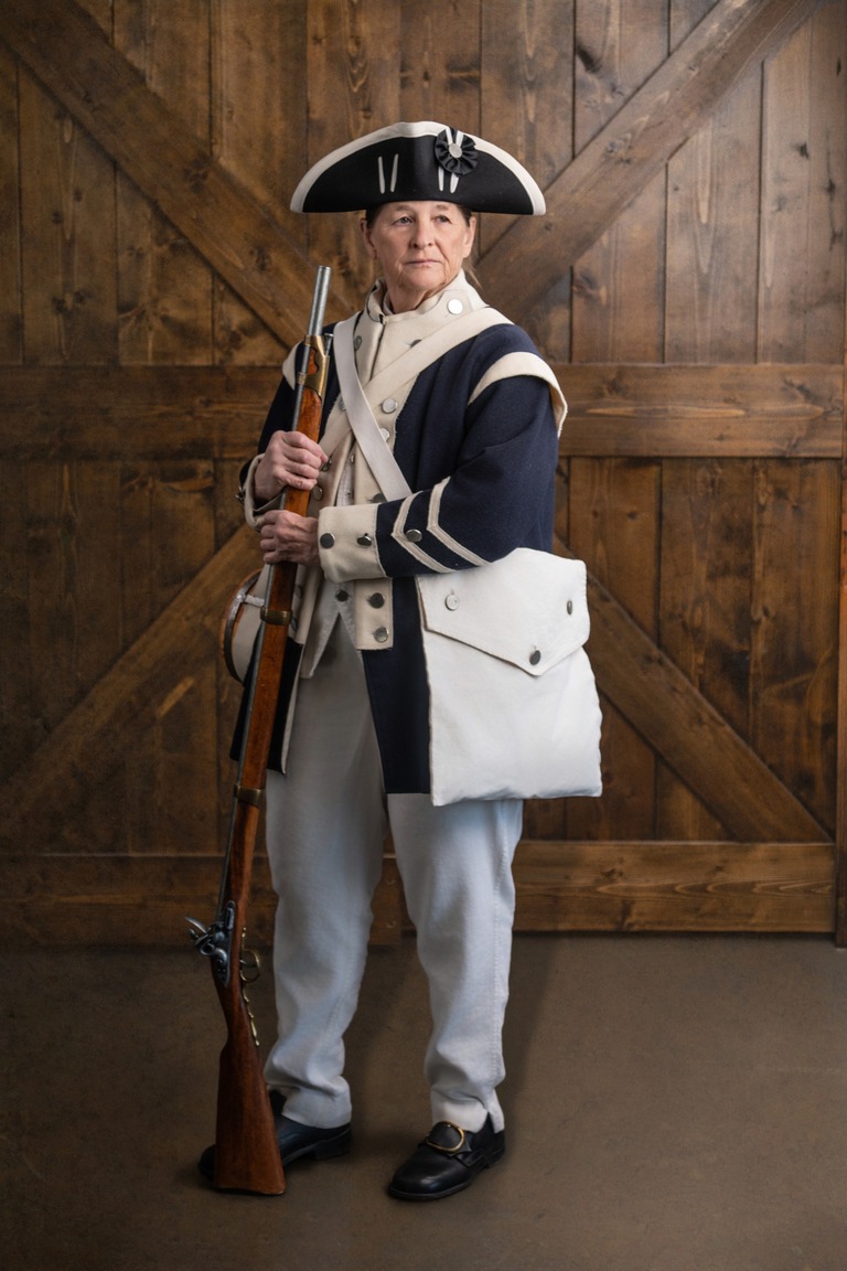 Woman in a Revolutionary War outfit standing at ease